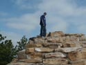 Greg and Chloe climb the rocks at the high point lookout in Guernsey, WY